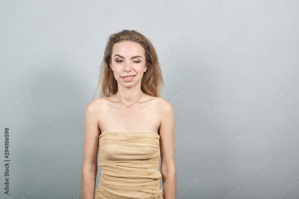 Beautiful girl in beige t-shirt over isolated white background shows emotions Beautiful girl in beige t-shirt over isolated white background shows emotions