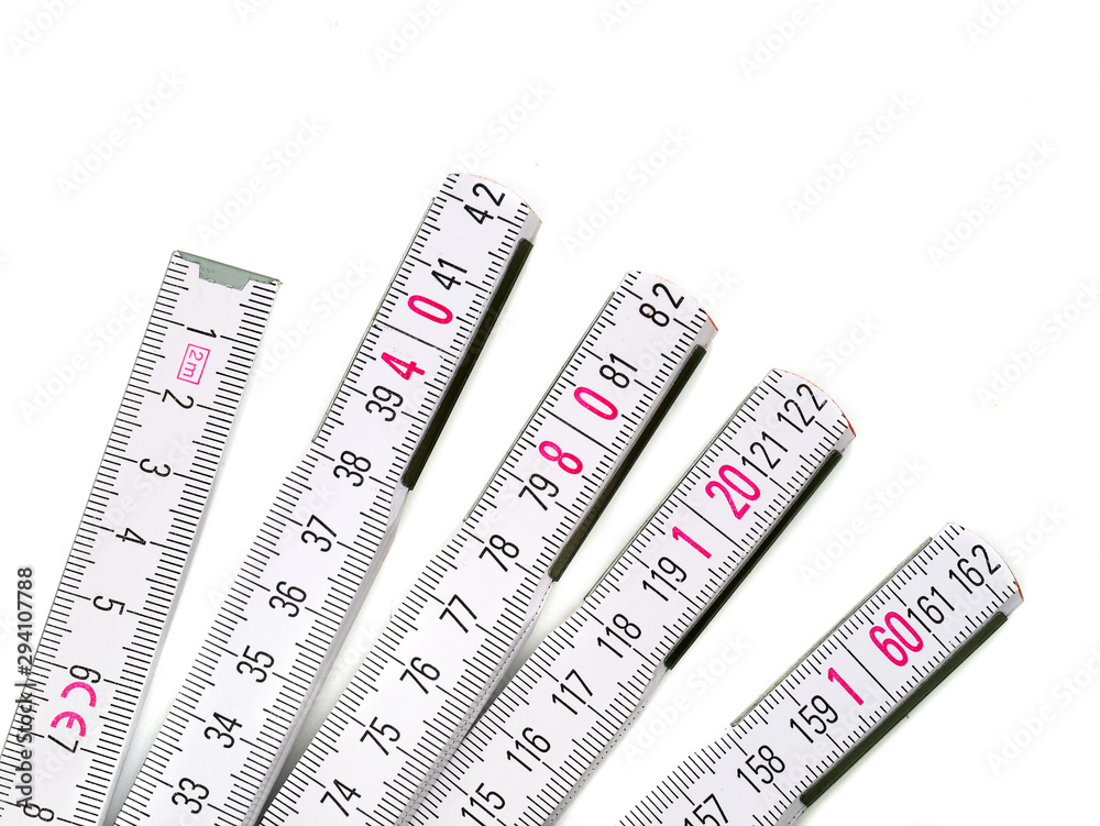 Close up of white yardstick with pink numbers isolated on white background Close up of white yardstick with pink numbers isolated on white background