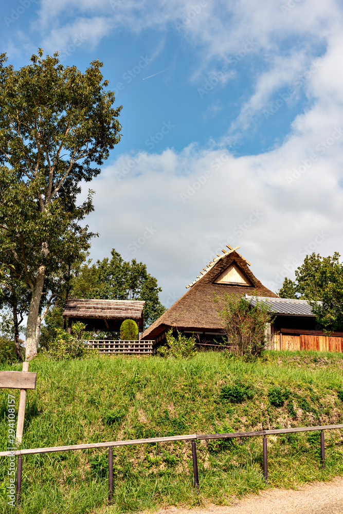 A traditional thatched roof Japanese house preserved at a public park in Sanda, Hyogo, Japan. A traditional thatched roof Japanese house preserved at a public park in Sanda, Hyogo, Japan.
