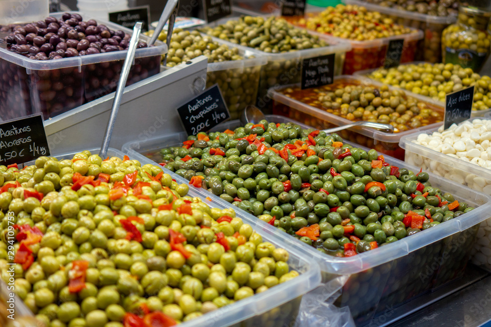 spanisch green Olives with pepper and pickled garlic for sale at farmers market in spain Malaga
