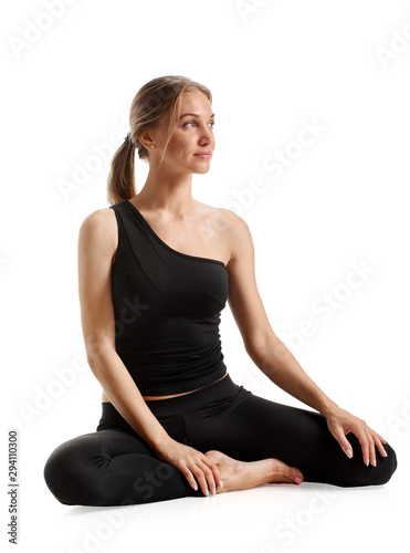 Young beautiful fitness woman posing on white background