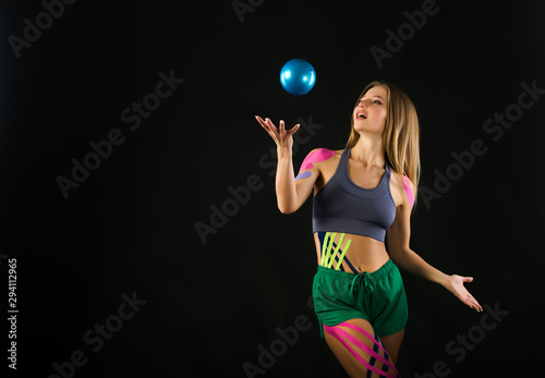 Girl trains with ball, color tapes