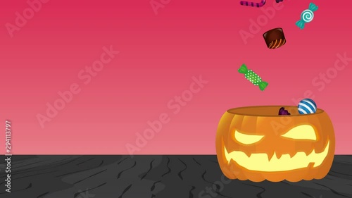 halloween pumpkin with zombie hand and sweet candies