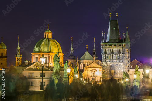 Night view of Old Town Bridge Tower and background of Church of St Francis Seraph at the bank of River Vltava, view from the Charles bridge.