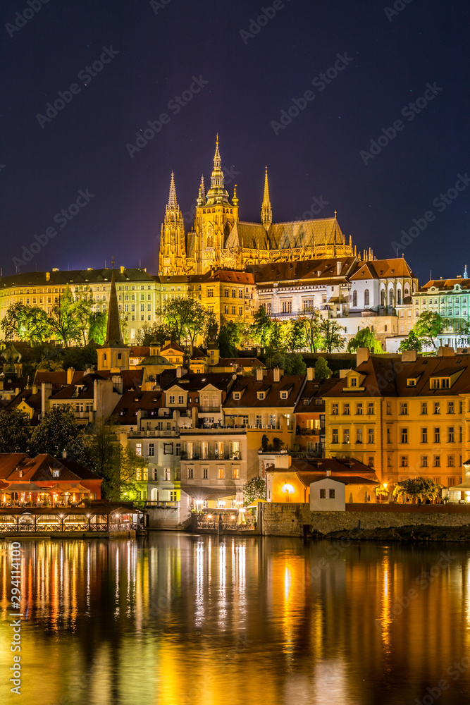 Night View of Prague castle, the largest coherent castle complex in the world, with the reflection on Vltava river.