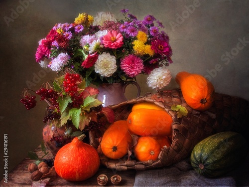 Still life with beautiful bouquet of flowers and autumn harvest