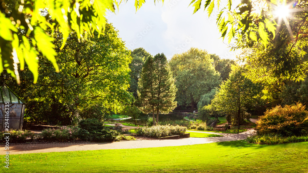 Naklejka premium Autumn city park with bird aviary and lake