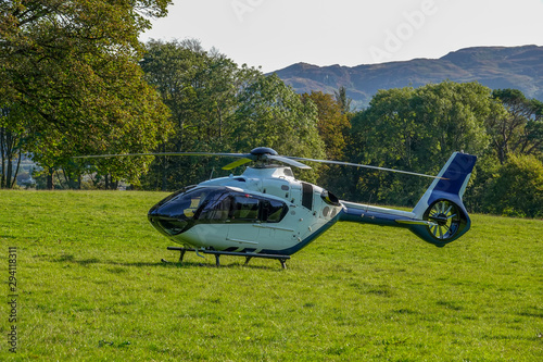 Helicopter landed in the middle of a field