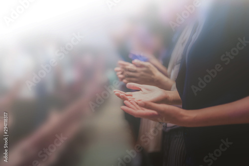 Soft focus of Christian worship with raised hand,m