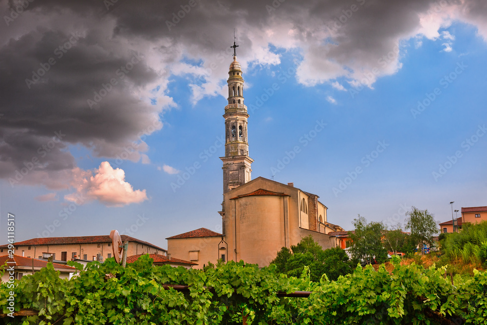 Obraz premium Rain is almost gone. Beautiful church in Monteforte d'Alpone, Italy surrounded by vineyards.