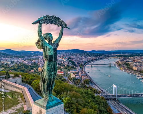 Budapest cityscapes form Gellert Hill with Citadella monument. Amazing sunset in the background. Included the Danube river, historical bridges, Budapest dwontown,  photo