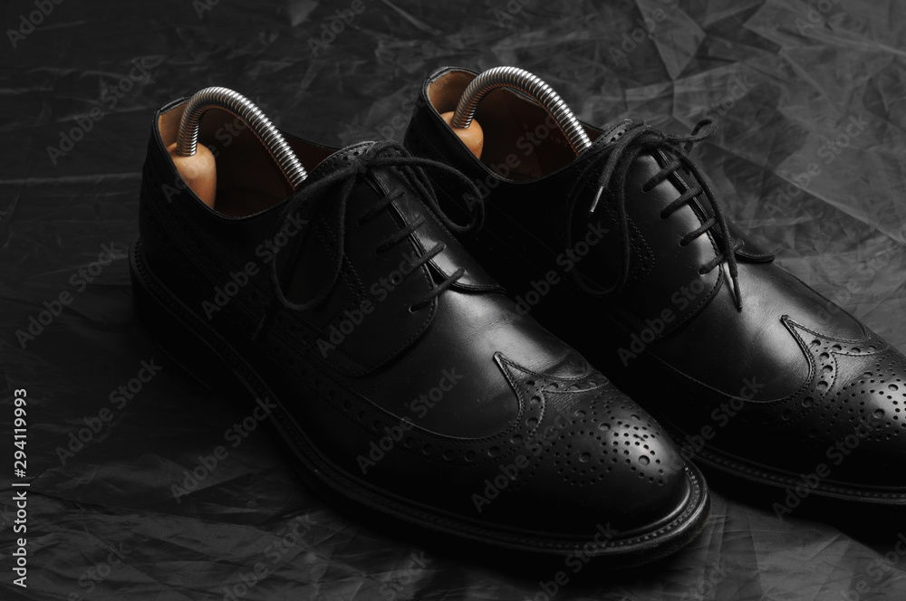 Leather black oxfords and brush. Studio photography Leather black oxfords and brush. Studio photography