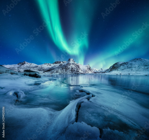 Aurora Borealis, Lofoten islands, Norway. Nothen light, mountains and frozen ocean. Winter landscape at the night time. Norway travel - image