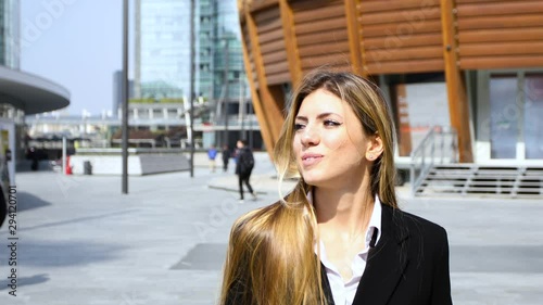 Wallpaper Mural Confident young female manager walking outdoor in a modern urban setting Torontodigital.ca