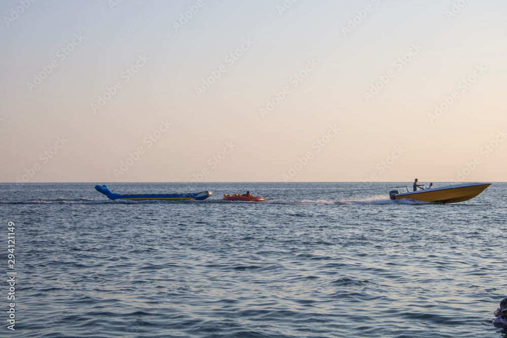 Riding on the Black Sea on an inflatable banana with an attached cable to the boat