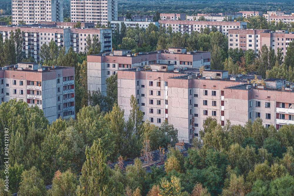aerial view of the lost city of Pripyat. a lot of empty concrete floors overgrown with trees. Pripyat is empty after the evacuation for 33 years after the accident at the Chernobyl nuclear power plant