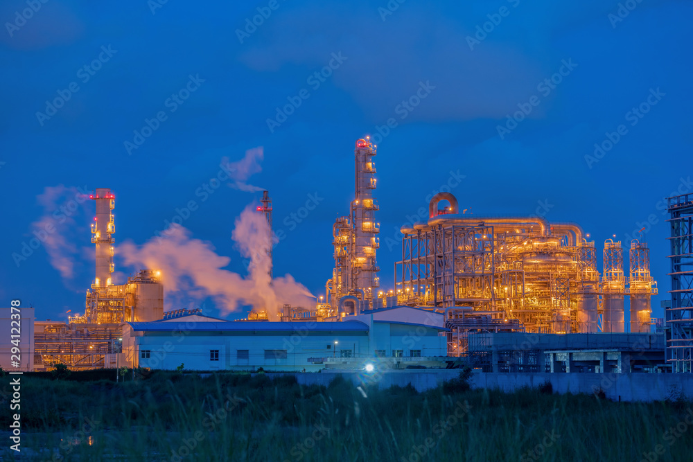 Industrial oil refinery plant form industry zone with  twilight at night,oil storage tank , factory equipment industry