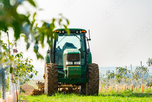 tractor cultivates agricultural land