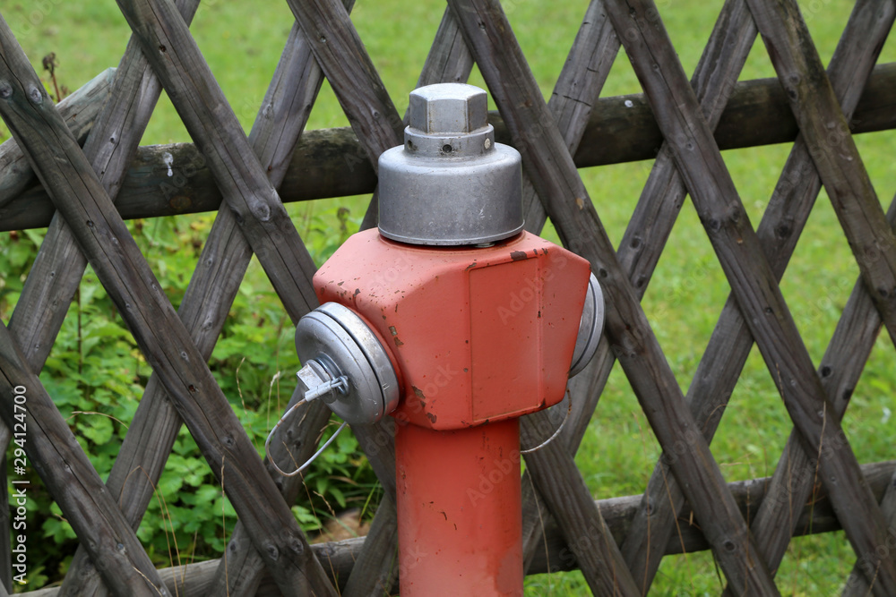 Typical red hydrant stands on the street Typical red hydrant stands on the street