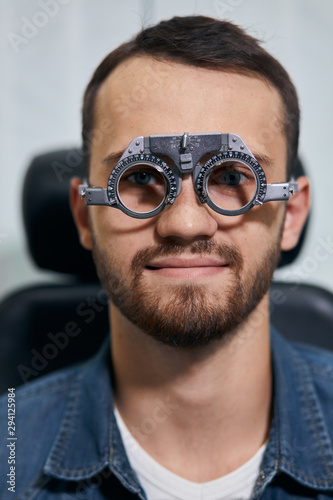 young man checking his eyesight, close up photo. medicine, treatmnet, man preparing for a surgery, operation