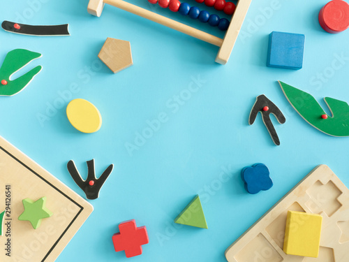 kids learning concept with stacking toys on blue table background.