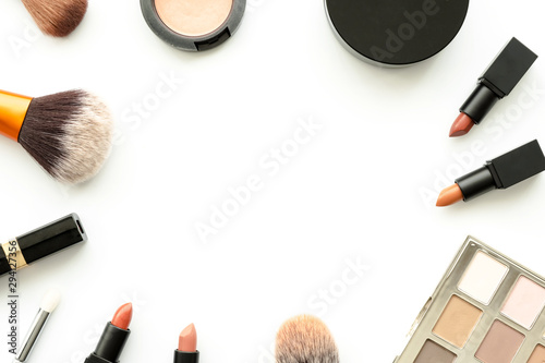 Flat lay image of beauty cosmetics make up with lipsticks, eye shadow palette, blush on, powder and brush. Top view with copy space, for your text.