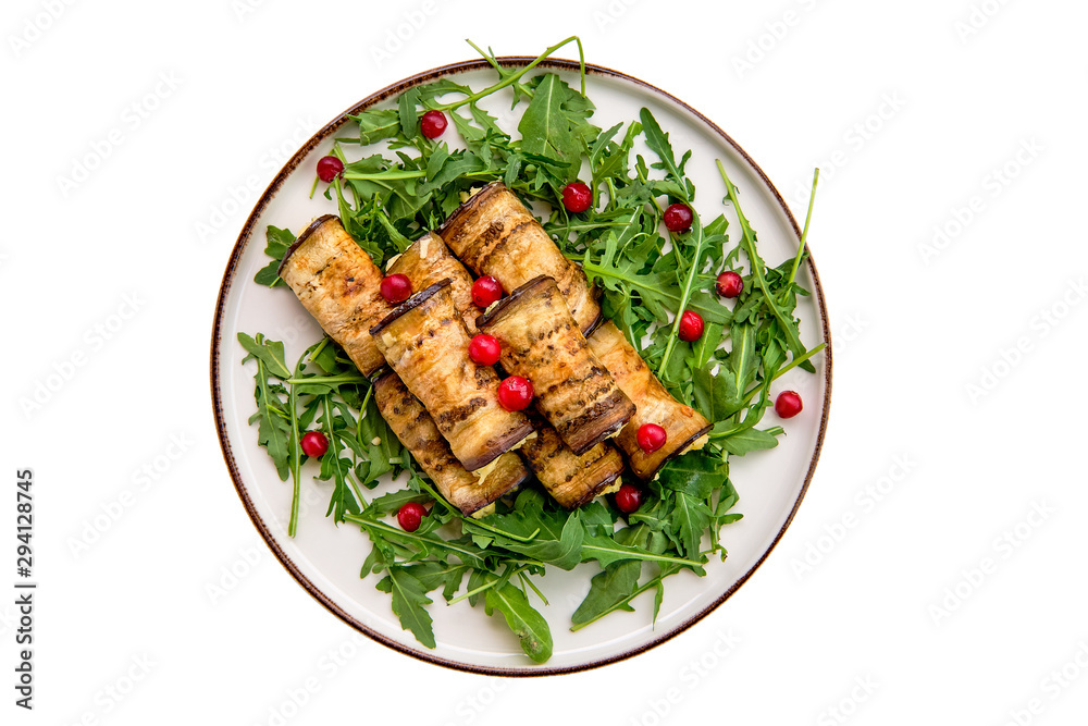 Eggplant rolls stuffed with soft cheese and garlic decorated with arugula and cranberry