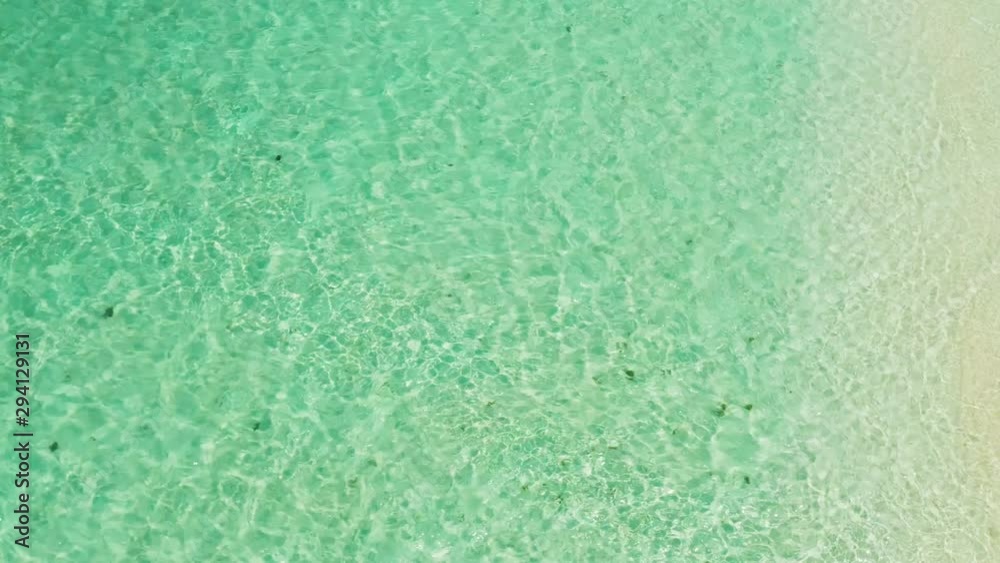 Sea water surface in lagoon. Transparent turquoise ocean water surface. Background texture.Turquoise sea water and beautiful shallows. Philippine nature. Sea surface.