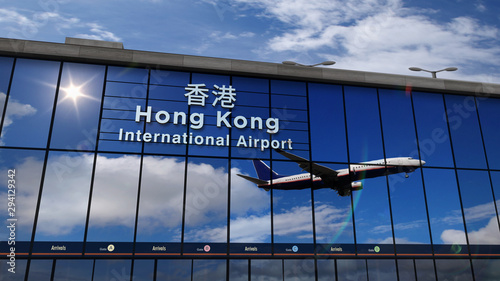 Airplane landing at Hong Kong mirrored in terminal
