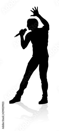A singer pop, country music, rock star or hiphop rapper artist vocalist singing in silhouette