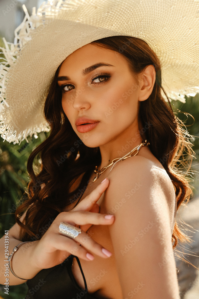 beautiful woman with dark hair in elegant dress posing in summer garden ...