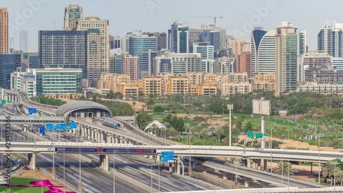 Dubai Golf Course with a cityscape of Gereens and tecom districts at the background aerial timelapse. Traffic on sheikh zayed road with junction and metro starion photo