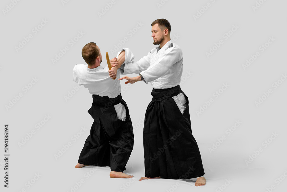 Two caucasian men are practicing aikido with waakizashi (isolation path included) Two caucasian men are practicing aikido with waakizashi (isolation path included)