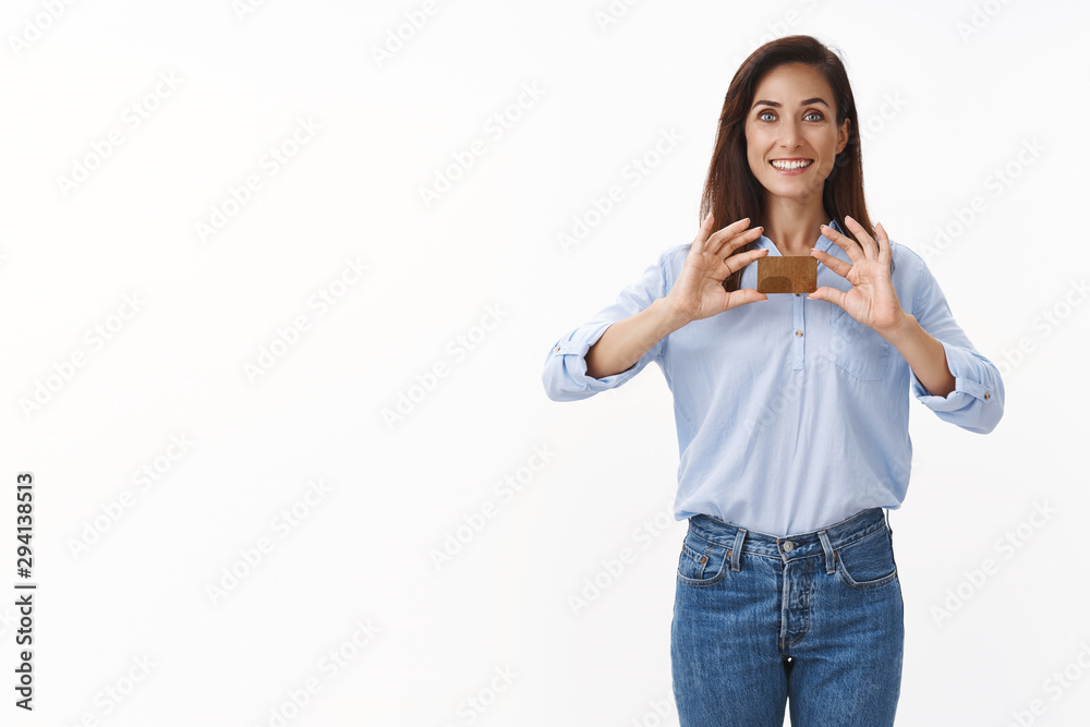 Finance, people and emotions concept. Happy woman satisfied receive gold credit card, making purchases online, smiling broadly, recommend bank, put money deposit, stand white background