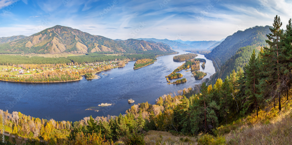 Autumn landscape. The Yenisei River flows through a picturesque valley. Blue water and islands. South of Western Siberia. 