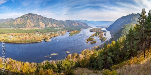 Autumn landscape. The Yenisei River flows through a picturesque valley. Blue water and islands. South of Western Siberia.  © Valerii