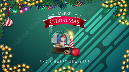 Merry Christmas and Happy New Year, green horizontal postcard with snow globe, garland and Christmas tree branch