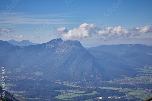 Mountain landscape in Austria, cloudy, forests, rocks, city in the mountains, summer