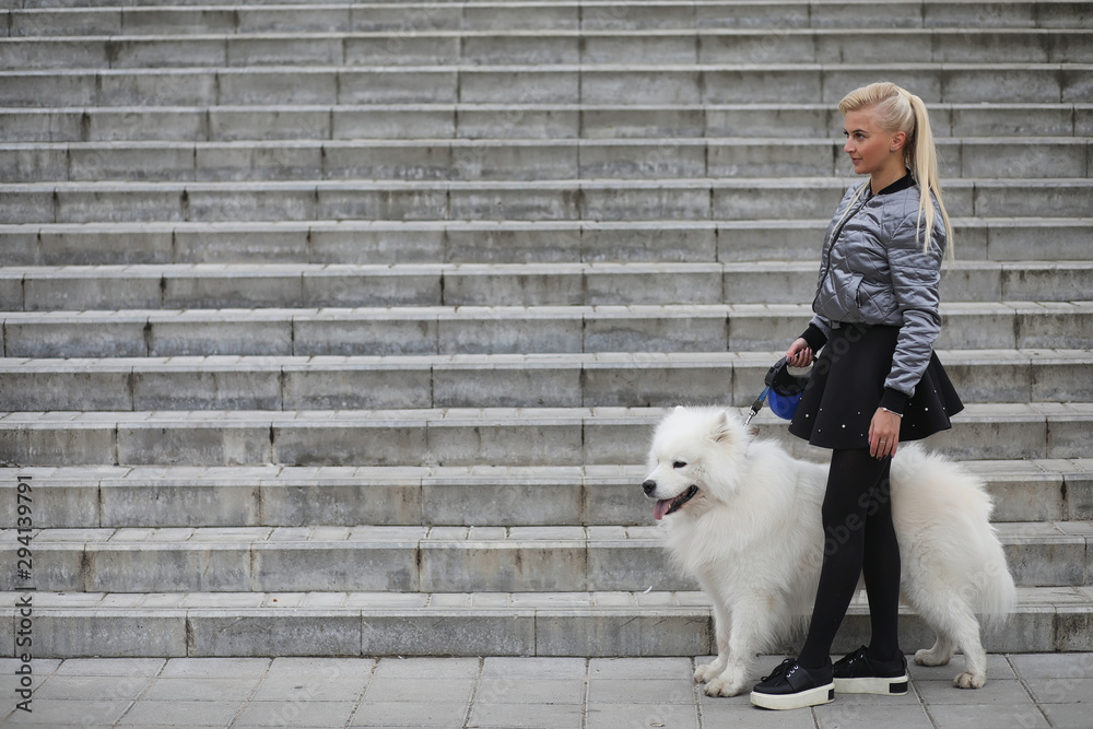 Lovely girl on a walk with a beautiful dog Lovely girl on a walk with a beautiful dog