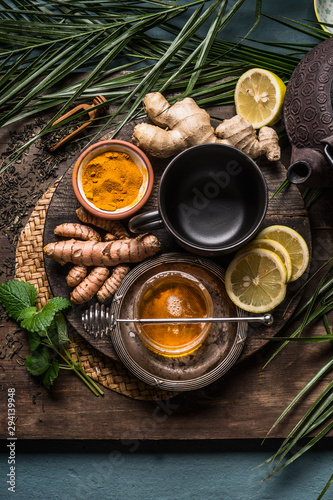 Preparation of Turmeric ginger tea with fresh ingredients, top view. Healthy herbal immune boosting