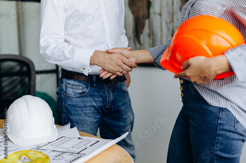 Two architects shaking hands after meeting in office