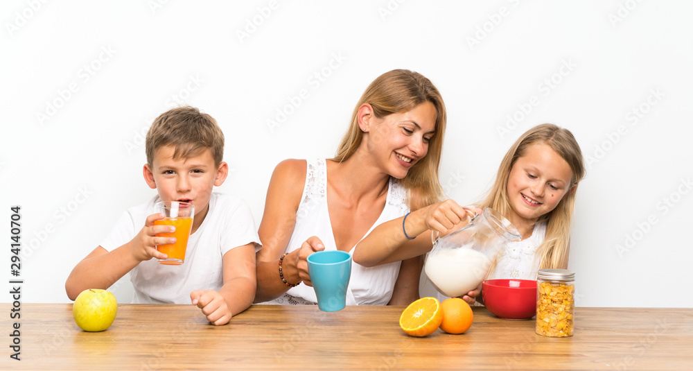 Mother with her two children having breakfast Mother with her two children having breakfast