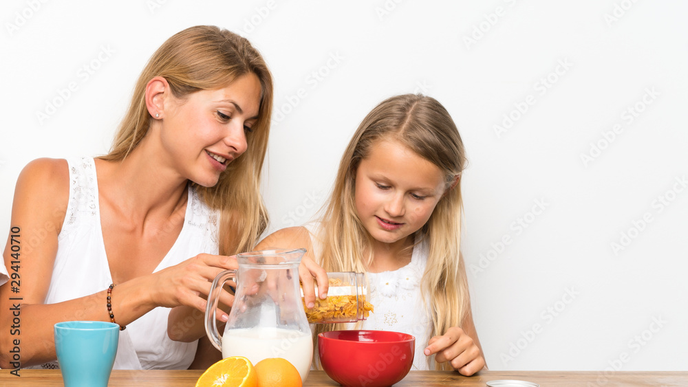 Mother with her two children having breakfast Mother with her two children having breakfast