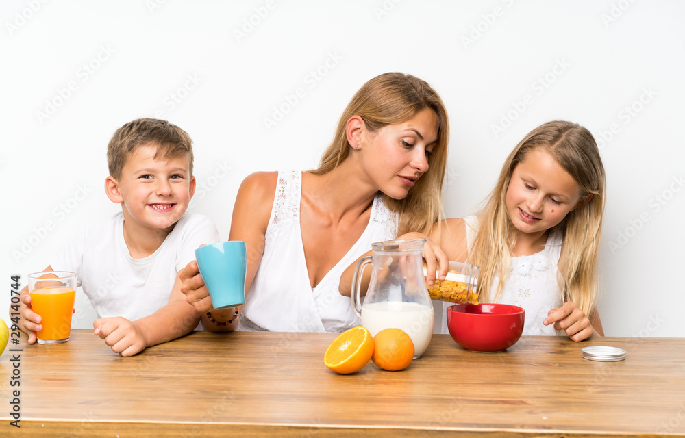 Mother with her two children having breakfast Mother with her two children having breakfast