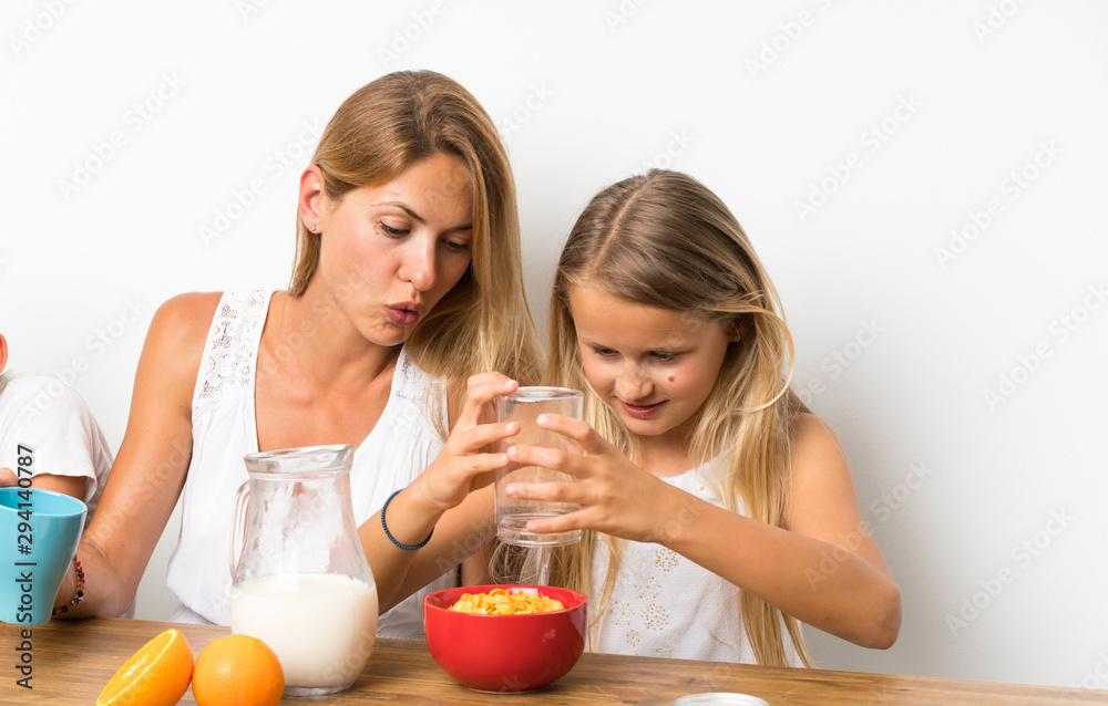 Mother with her two children having breakfast Mother with her two children having breakfast
