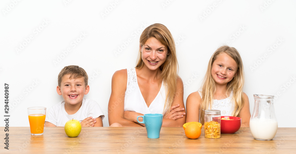Mother with her two children having breakfast Mother with her two children having breakfast