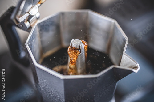 Brewing black moka coffee using moka coffee maker photo