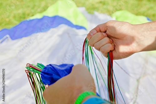 pull and fold the slings of the paraglider equipment and paragliding stuff 