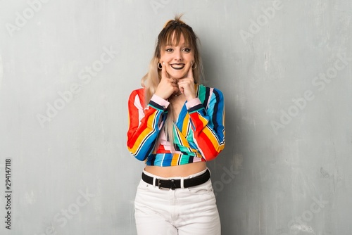 Young  girl with colorful clothes smiling with a happy and pleasant expression