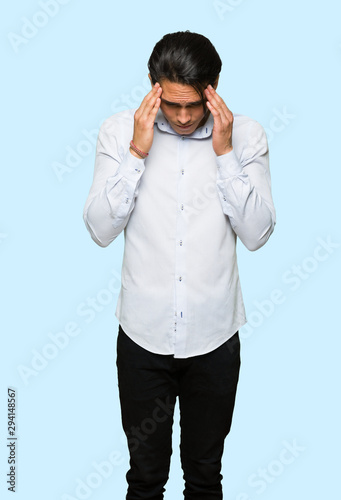 Handsome man unhappy and frustrated with something over isolated blue background